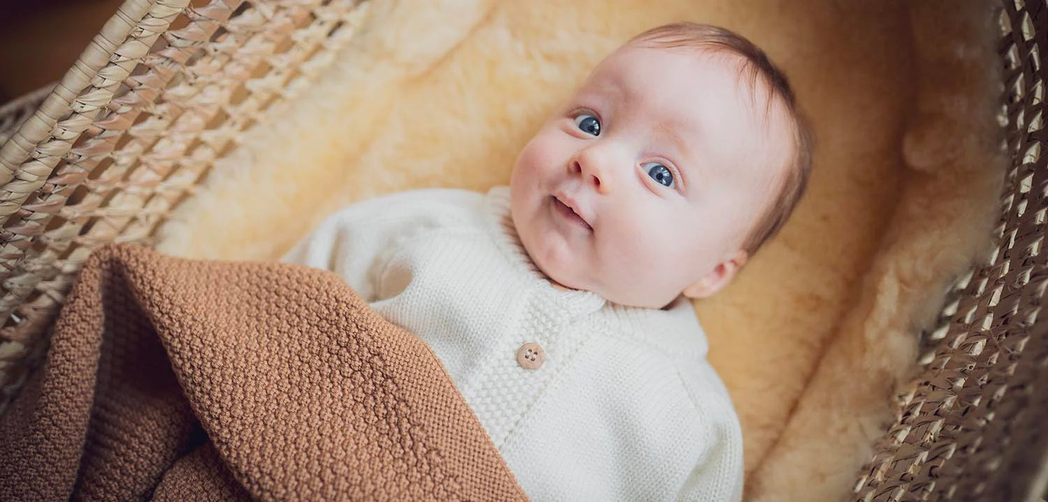 Close up of a cute baby smiling and wearing mamelo clothes